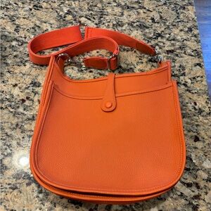 Beautiful orange Crossbody messenger bag, never used brand new! Includes strap!